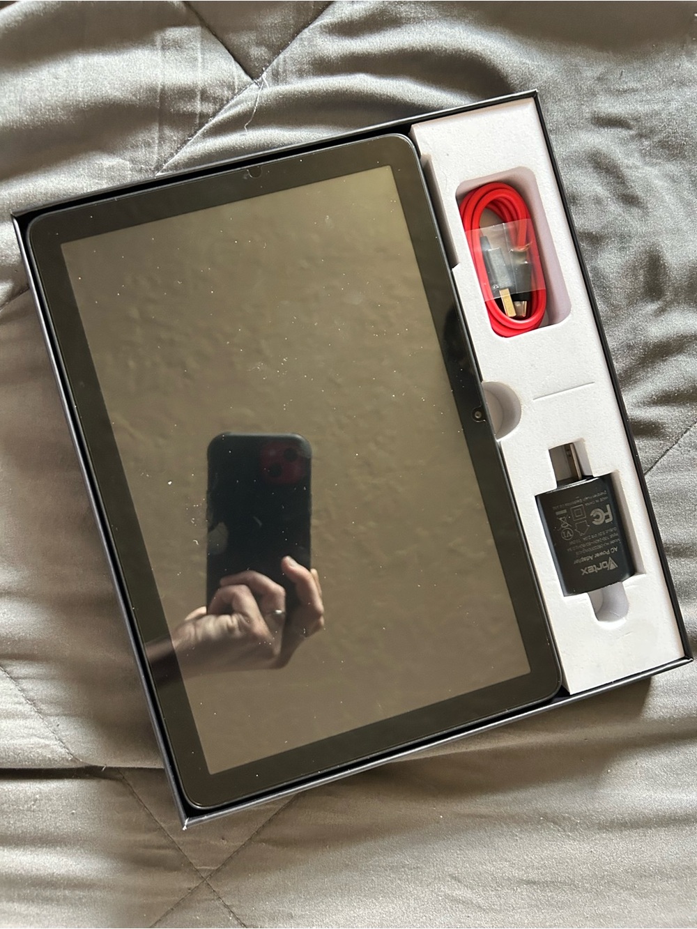 Black Tablet with Red Charging Cable and Wall Adapter
